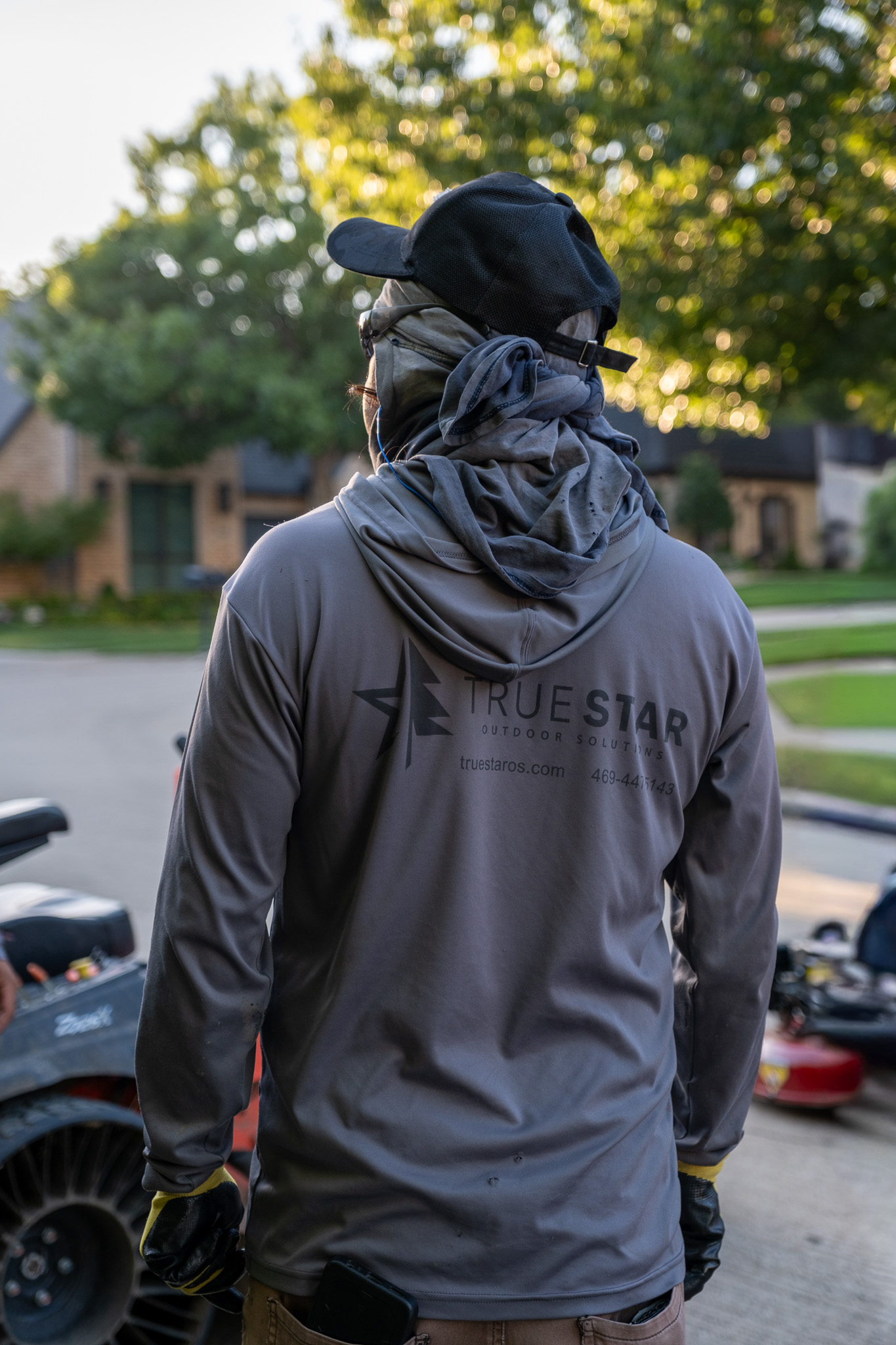True Star crew member in branded gear at community property